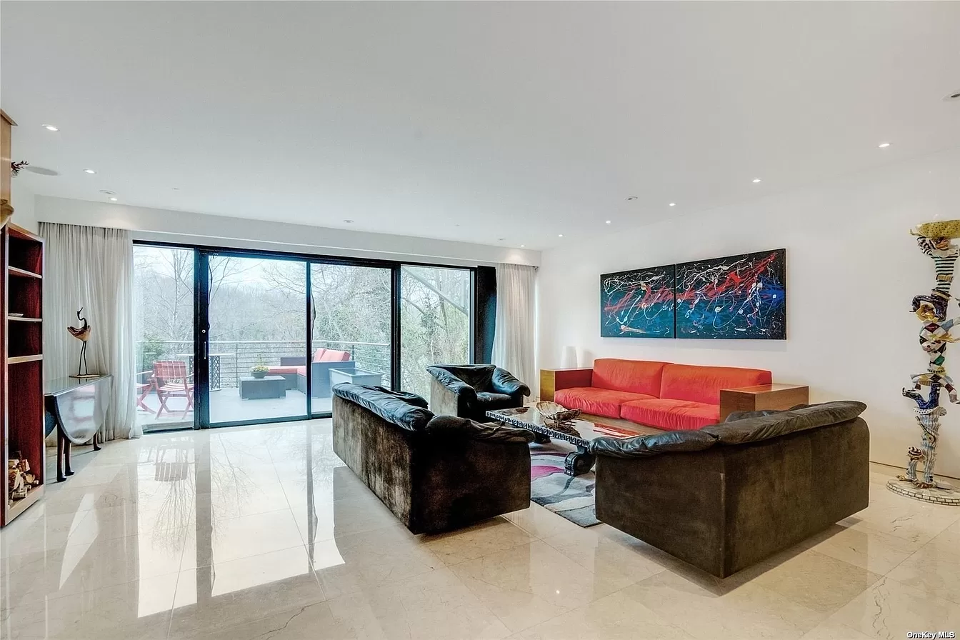 car interior from central back seat position showing driver and blurred view through windscreen of a busy road at night