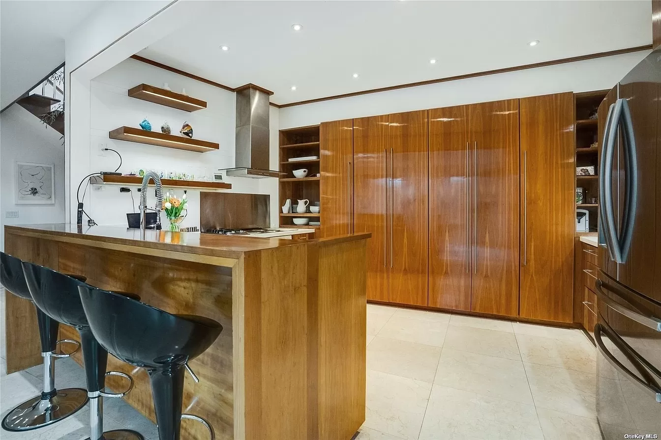 car interior from central back seat position showing driver and blurred view through windscreen of a busy road at night